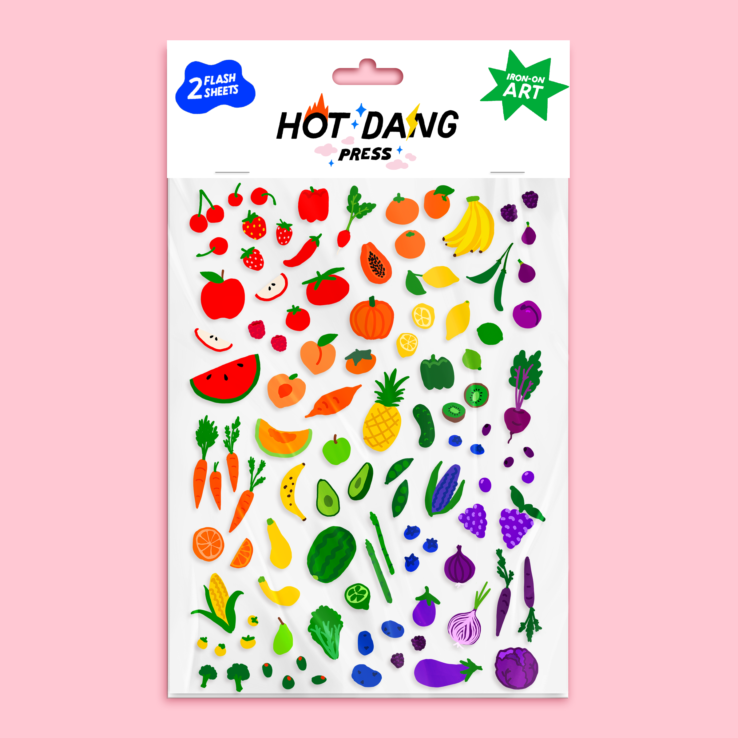 Sheet of colorful fruit and vegetable iron-ons in a rainbow by Hot Dang Press on a pink background